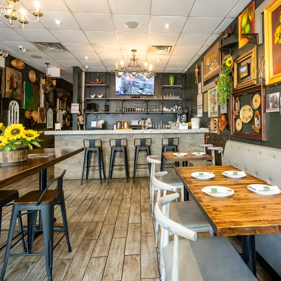 Interior of Link Thai restaurant with a bar, dining tables, and eclectic wall decor.